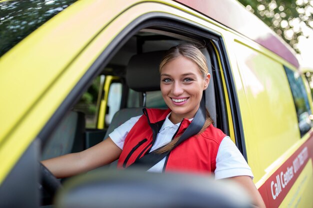 Ambulance staff members in her ambulance She is wearing ambulance uniform of paramedics She is sitting in the ambulance ready to go to a call