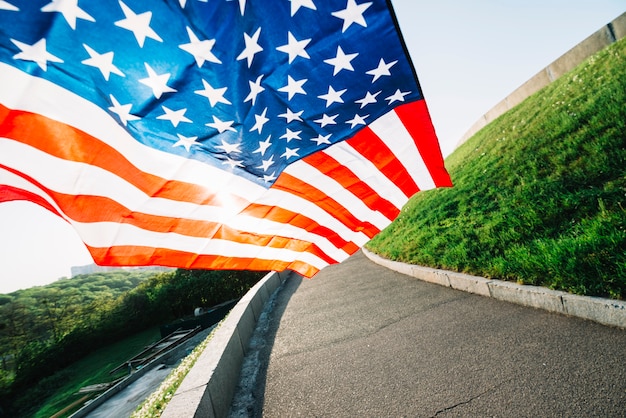 Free photo american flag with road and sunshine