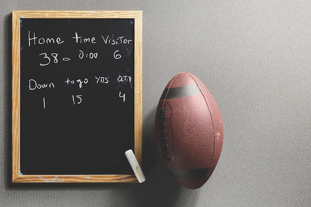 Free photo american football ball lying near match score