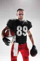 Free photo american football player posing with ball