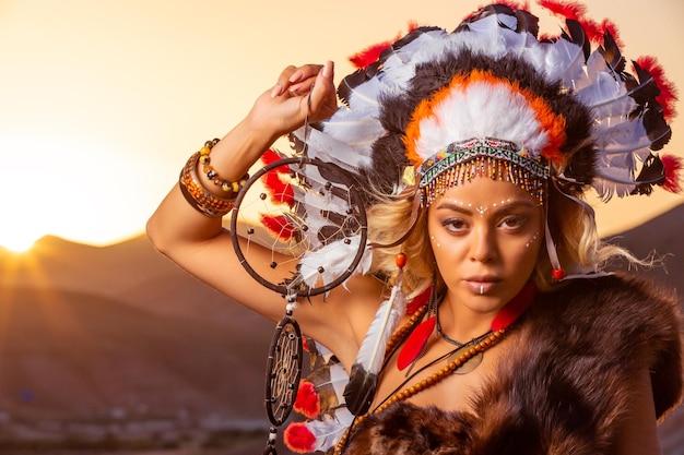 American Indian girl in native costume headdress made of feathers of birds