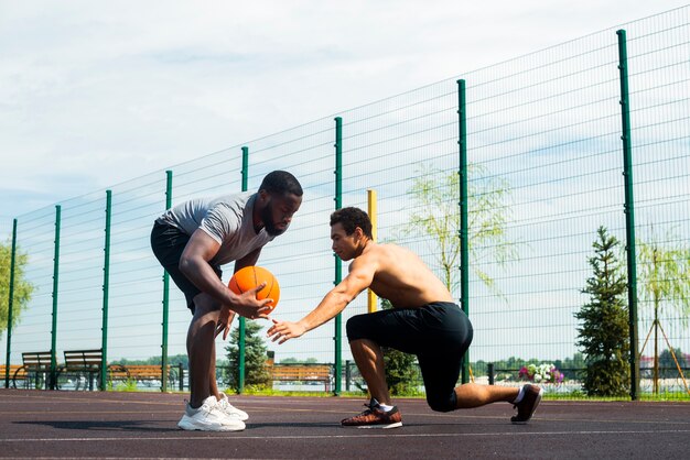 American men playing urban basketball long shot