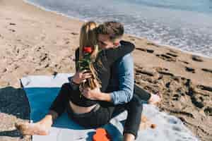 Free photo amorous people embracing gently on beach