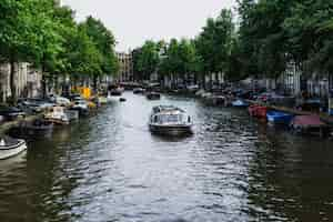 Free photo amsterdam canals, boats walk on water