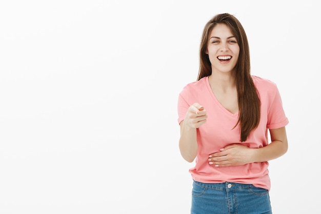 Amused brunette woman posing in the studio