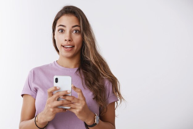 Amused caucasian woman using  smartphone