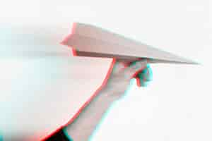 Free photo anaglyph effect on hand holding paper plane