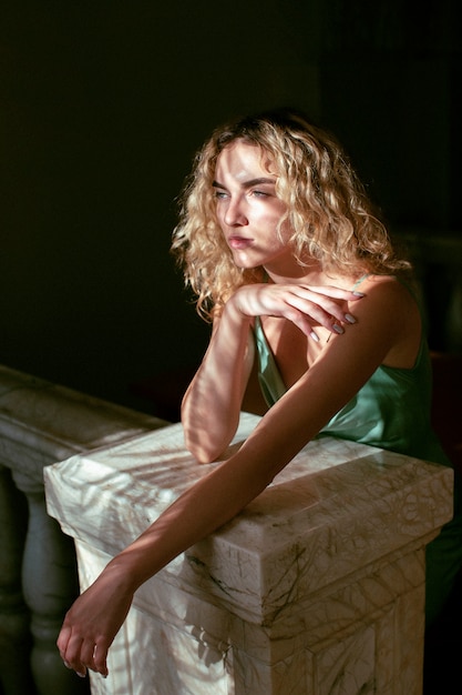 Free photo analog portrait of beautiful woman posing indoors in an elegant dress