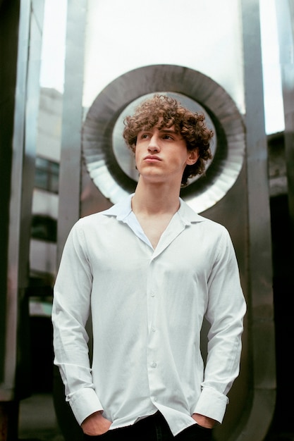 Free Photo analog portrait of handsome man posing artistically outdoors