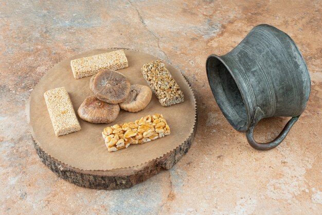 Ancient kettle and peanut brittles on marble background