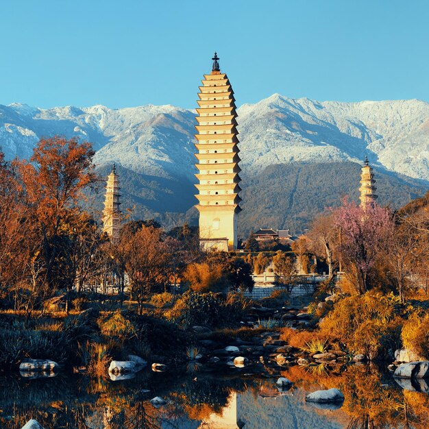 Ancient pagoda in Dali old town with snow capped Mt Cangshan, Yunnan, China.