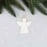 Free photo angel ornament with fir branch