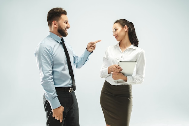 Free photo angry boss. man and his secretary standing at office or studio.