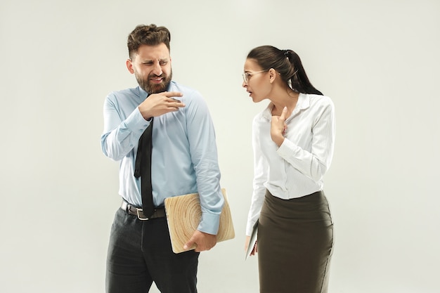 Free photo angry boss. man and his secretary standing at office