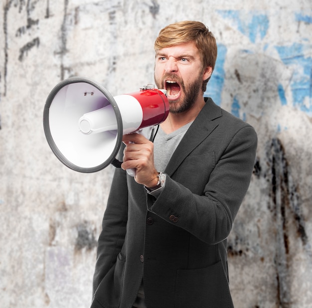 Angry businessman making an announcement with bullhorn