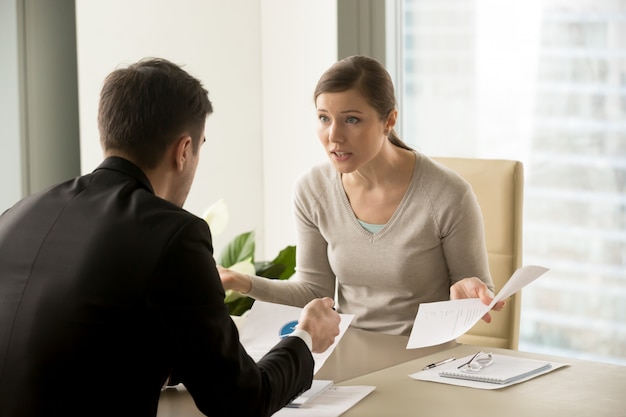 Angry businesswoman arguing with businessman