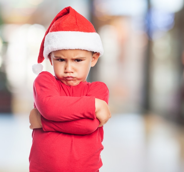 Angry little boy with santa hat