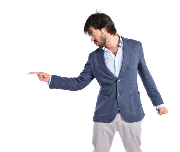 Angry man pointing somebody over isolated white background