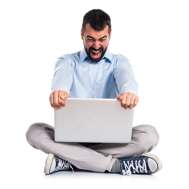 Angry man with laptop shouting