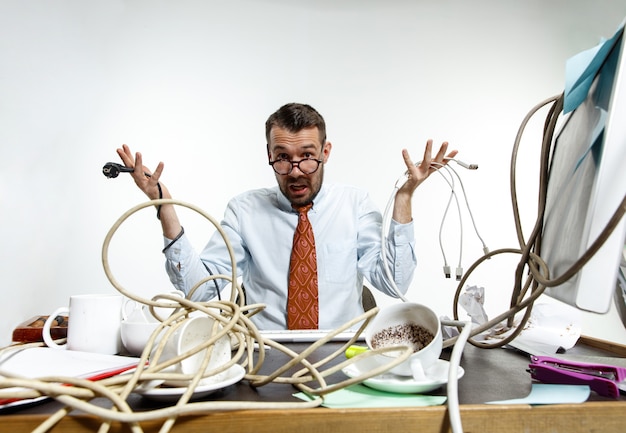 Free photo angry man with wires on his desk