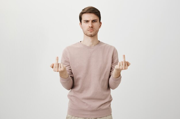 Angry rude guy showing middle-fingers