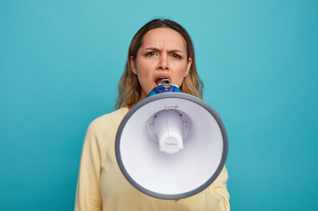 Angry young girl shouting in loud speaker 