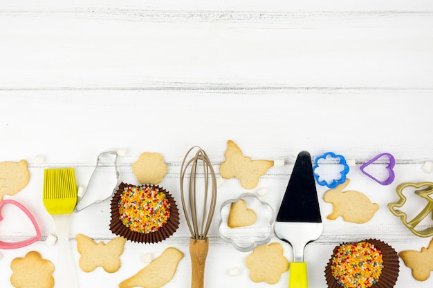 Free Photo animal shaped cookies with kitchen utensils 