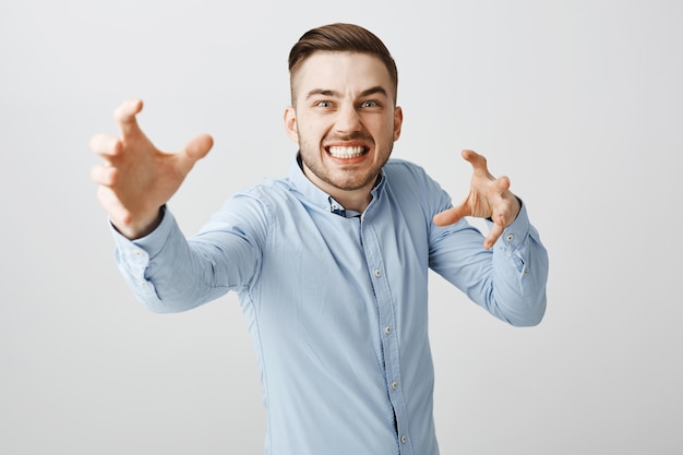 Free Photo annoyed businessman look angry reaching hands forward to strangle someone