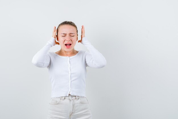 Annoyed girl doesnt want to hear anything on white background