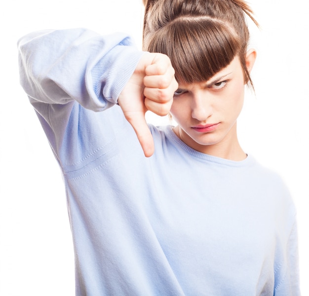 Free photo annoyed teenager showing thumb down