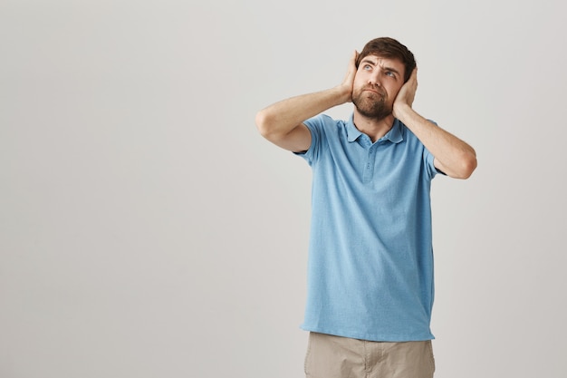 Annoyed young bearded man posing