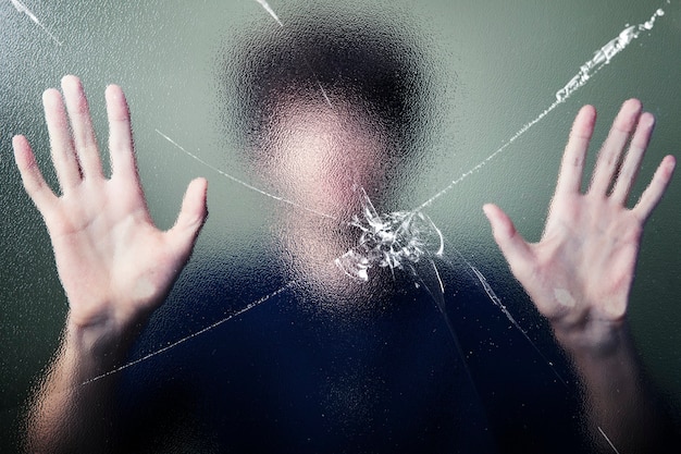 Anonymous man with cracked glass effect