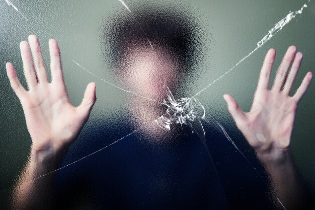 Anonymous man with cracked glass effect