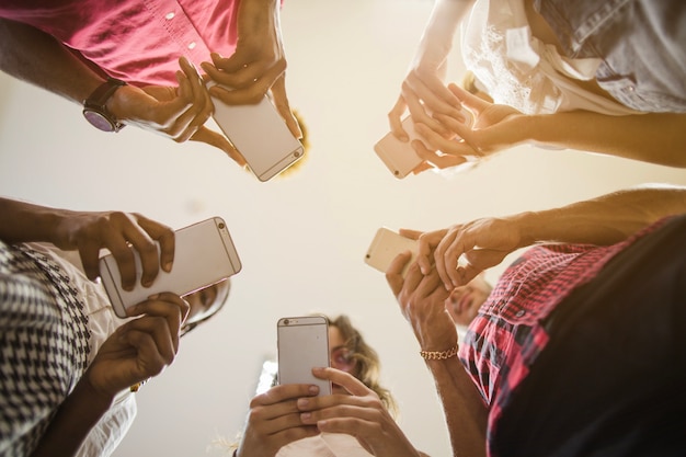 Anonymous people busy with smartphones