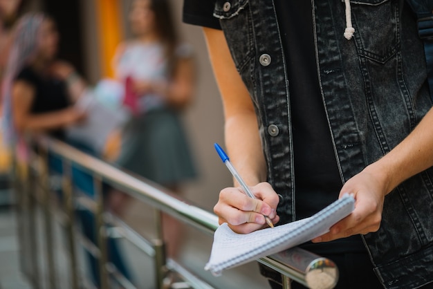 Anonymous student writing in notepad