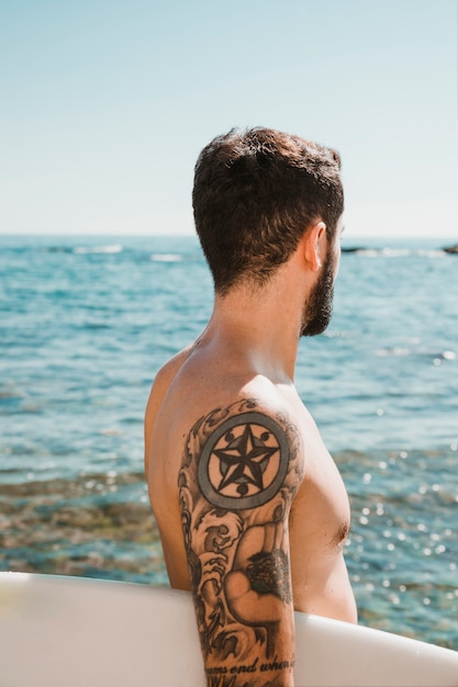 Free Photo anonymous surfer looking at waving sea