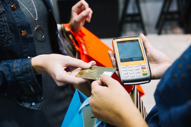 Anonymous woman paying in shop