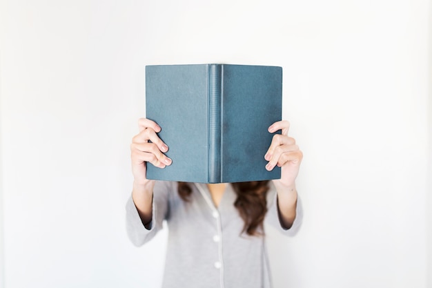 Anonymous woman reading book