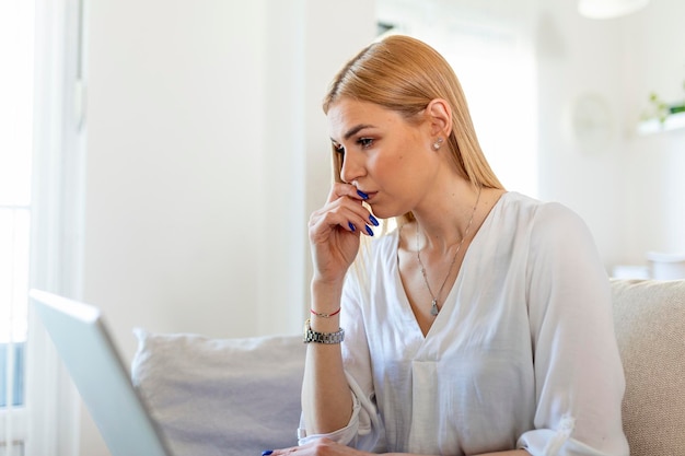 Free photo anxious depressed woman sitting with laptop looking nervous worried scared of deadline stressful job