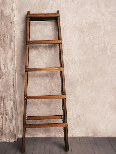 Apartment Renovation. Wooden Ladder in empty Room