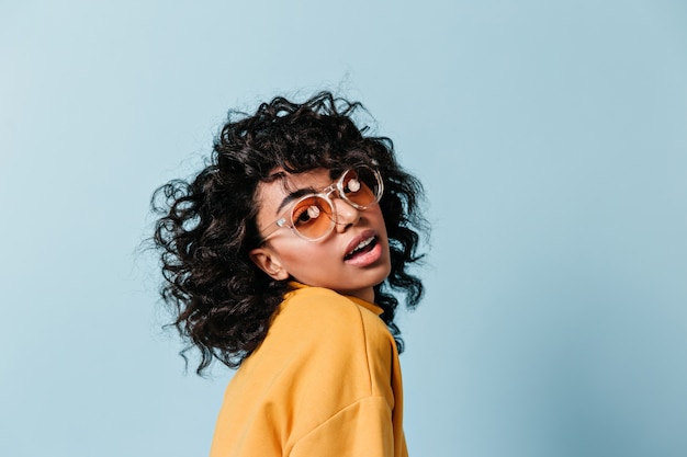 Free photo appealing curly woman posing in sunglasses