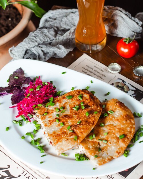 Appetizer served with cabbage, chopped scallions and basil