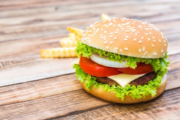 Appetizing cheeseburger with chips background