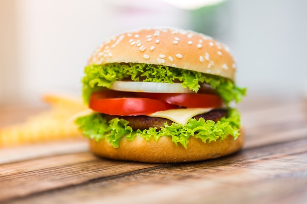 Appetizing cheeseburger on wooden table