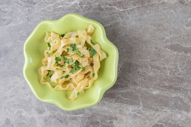 Appetizing classic Italian spaghetti pasta in the bowl , on the marble.