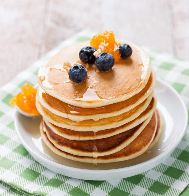 Appetizing pancakes with honey and marmalade