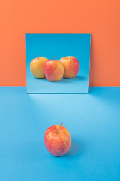 Free photo apple on blue table isolated on orange