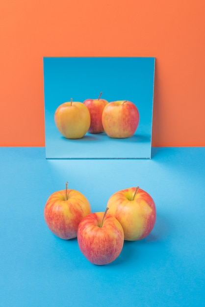 Free photo apple on blue table isolated on orange