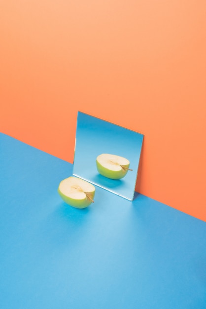 Apple on blue table isolated on orange