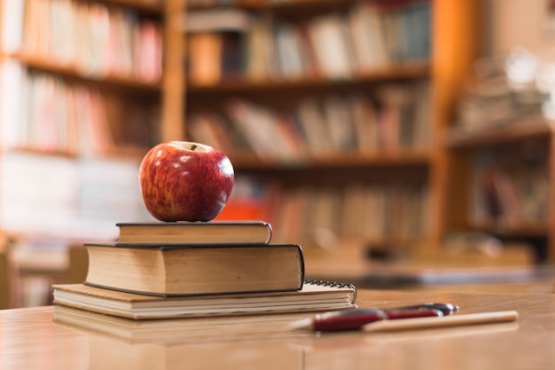 Free photo apple on books in library